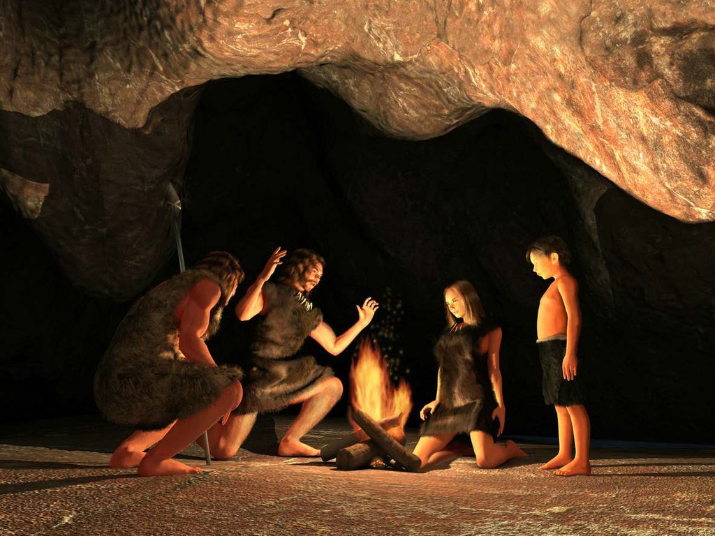 Ilustración de personas en cuerva prehistórica en torno a fogata