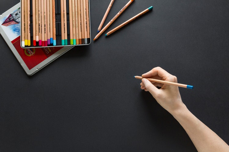 Blue pencil against black paper